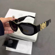 Black box frame sunglasses with gold metallic temple emblem, UV protection lenses, and comfortable fit.