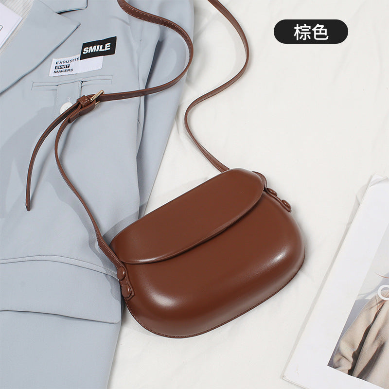 Curved Saddle Crossbody Bag with Flap Closure