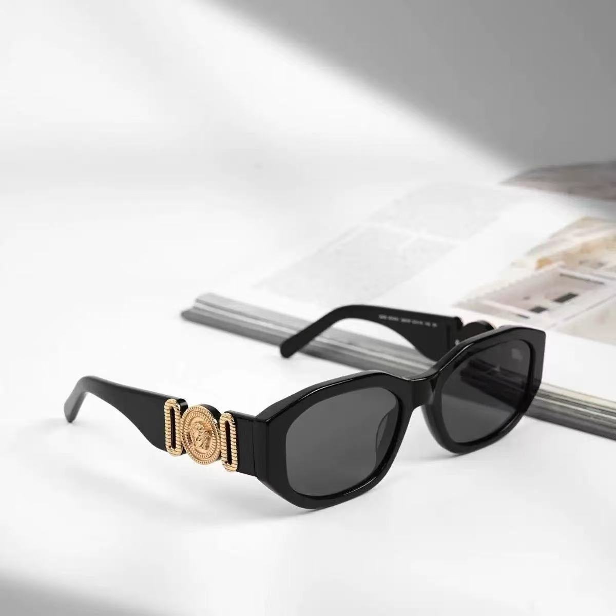 Black box frame sunglasses featuring a gold metallic temple emblem and UV protection lenses for safe, comfortable wear.