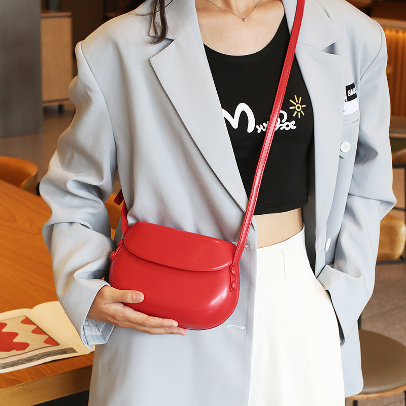 Curved Saddle Crossbody Bag with Flap Closure