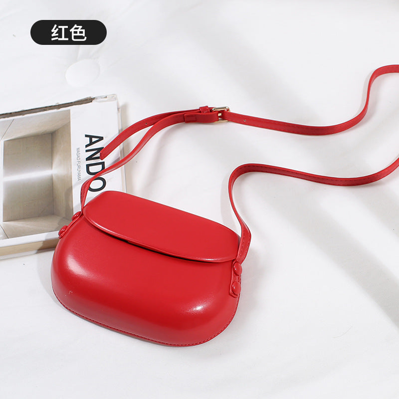 Curved Saddle Crossbody Bag with Flap Closure
