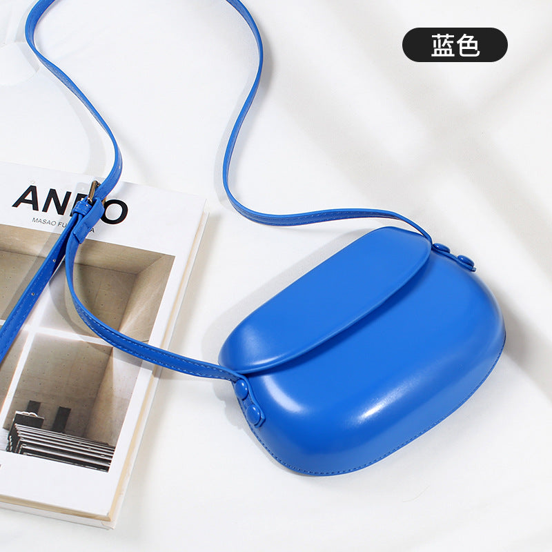 Curved Saddle Crossbody Bag with Flap Closure