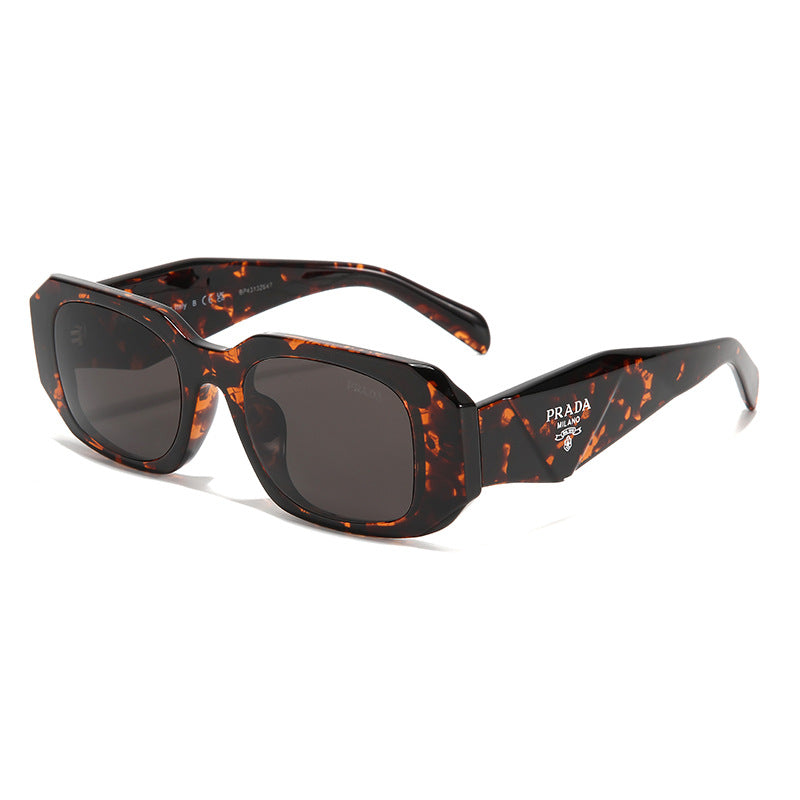 Tortoise square frame sunglasses with dark lenses featuring a white logo on the temple.