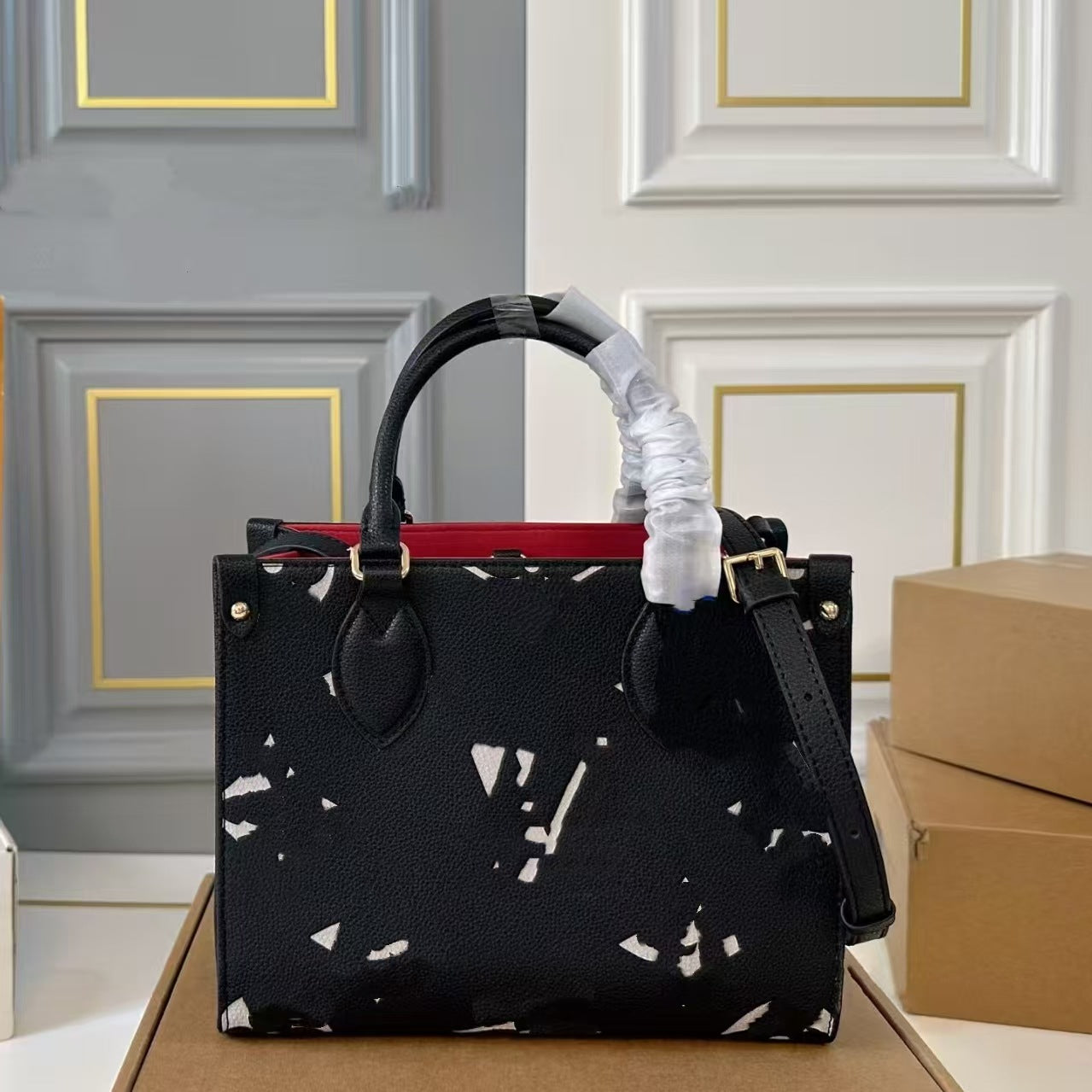 Elite black leather shoulder tote bag with white geometric pattern and red interior lining.