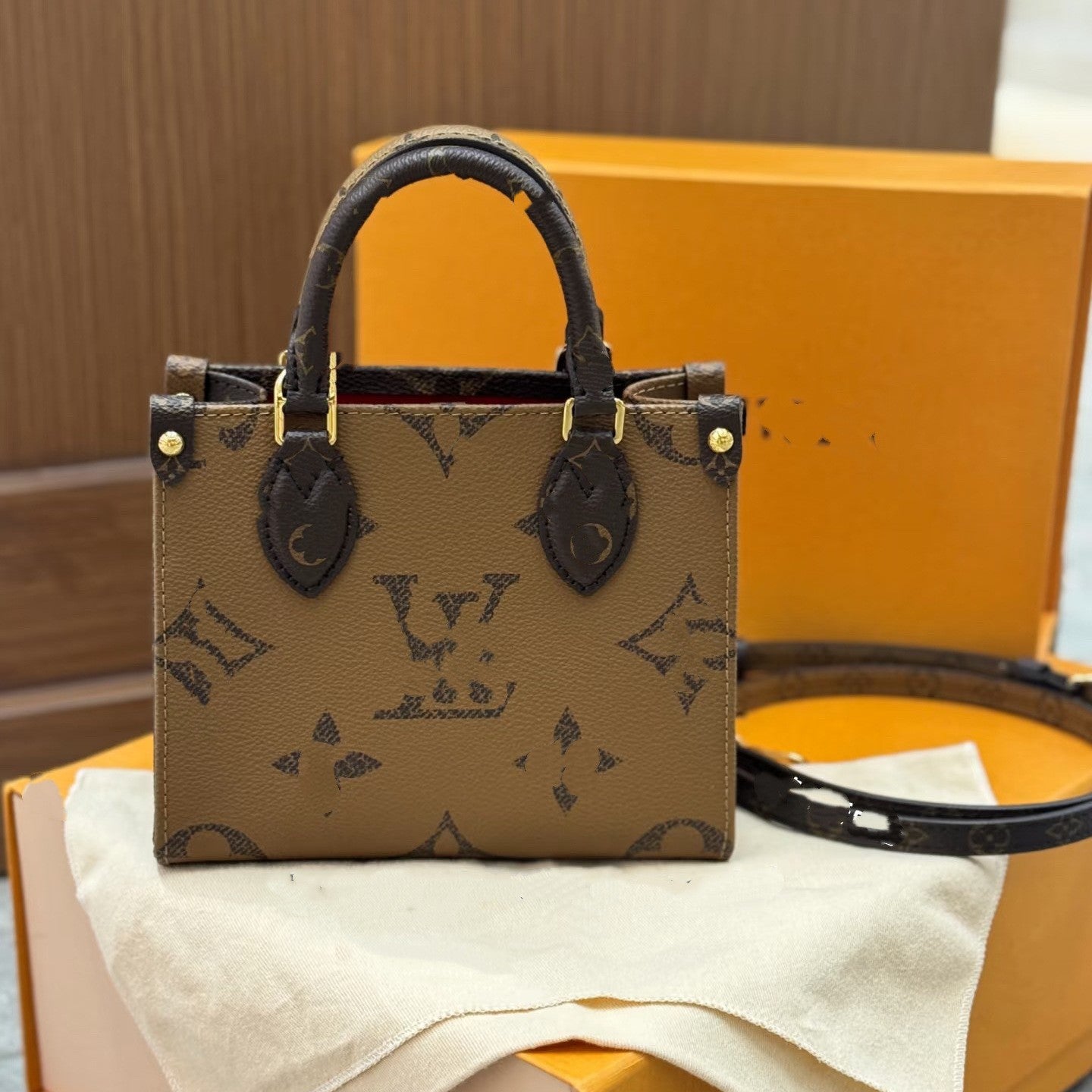Structured premium women's tote with detachable strap and gold hardware in light brown monogram.